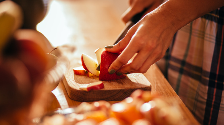 woman cutting up an apple