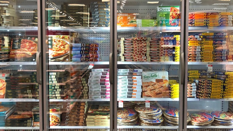 Various frozen pizzas in grocery store