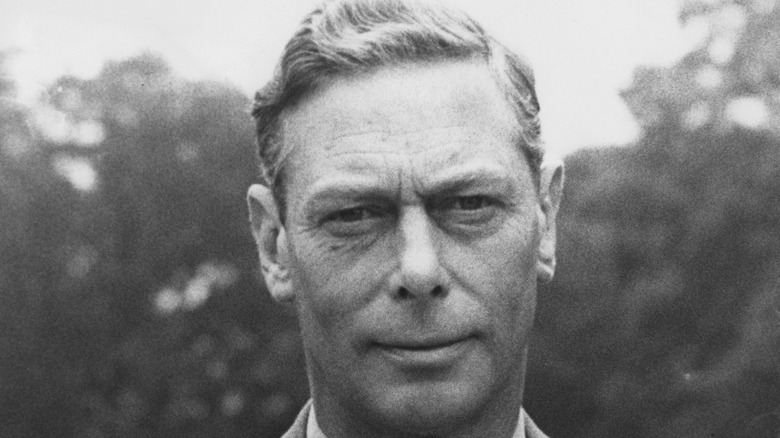 A black-and-white close-up of George VI, King of Great Britain, in the grounds of the Royal Lodge, Windsor