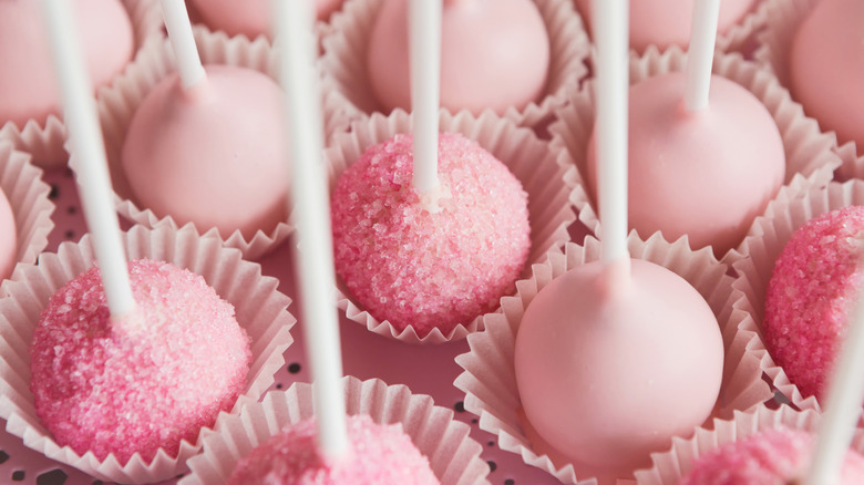 Close up of a platter of pink cake pops.
