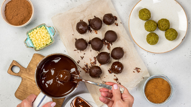 Person making pistachio marzipan balls